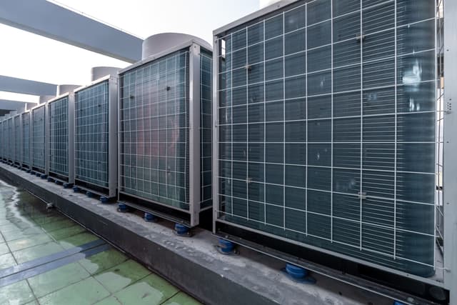 A row of air conditioners in a building.